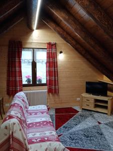 a bedroom with two beds and a television in a attic at BAITA SIBERIA in Craveggia