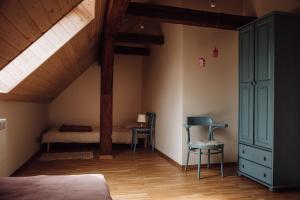 a attic room with a bed and a desk and chair at Osada pod Lipą in Ostrowice +57 photos
