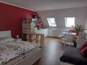 a bedroom with a bed and a dining room at Ferienwohnung Grunwald in Oberhof