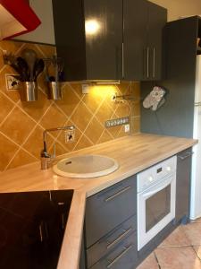 a kitchen with a sink and a counter top at Gite des oliviers in La Roque-sur-Cèze