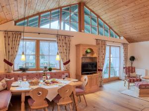 a large living room with a table and chairs at Ferienwohnungen Mayer inkl. Chiemgaukarte in Ruhpolding