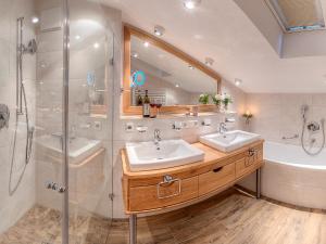 a bathroom with two sinks and a shower at Ferienwohnungen Mayer inkl. Chiemgaukarte in Ruhpolding +63 photos
