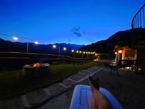 a person laying on a bench in front of a fire at IL SANTO GRAAL in Triora