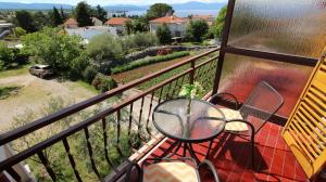 a balcony with a table and chairs and a view at Room Jelka 3 in Malinska