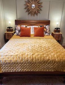 a bedroom with a large bed with orange pillows at The Crown Inn Dial Post in Horsham