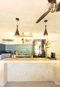 a kitchen with a stove top oven and a sink at Viva Merida Hotel Boutique in Mérida