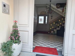 a christmas tree in a pot in a hallway with a staircase at K5-Suites in der Altstadt Annaberg-Buchholz in Annaberg-Buchholz