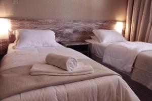 Cama ou camas em um quarto em Samuara Hotel Caxias do Sul
