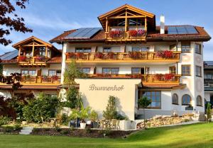 a large hotel with a sign that reads summermont at Hotel Brunnenhof in Bayerisch Eisenstein