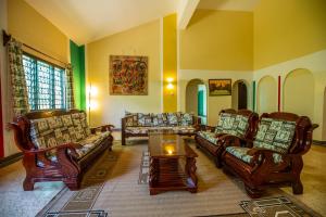 a living room with couches and a table at Jamboland-Diani in Diani Beach