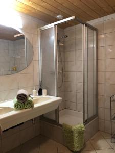 a bathroom with a shower and a sink and a mirror at Appartement Bichl in Sölden
