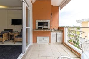 um quarto com uma varanda e uma lareira em Férias Jurerê-apto 2 suítes para 6 pessoas VDI208 em Florianópolis