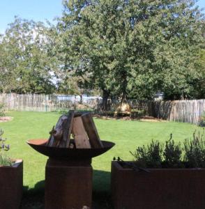 a bird feeder in a yard with a fence at B&B Den Biesthoek in Grimbergen