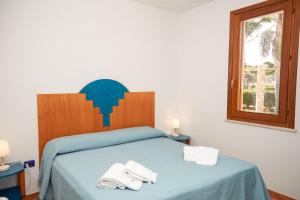 A bed or beds in a room at Residence I Faraglioni