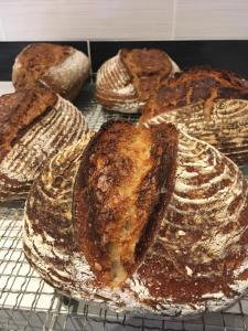 a bunch of loaves of bread sitting on a rack at Ronas House in Inverness