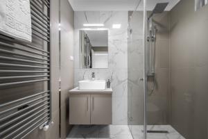 a bathroom with a sink and a shower at Hévízi Tópark Panzió II. in Hévíz