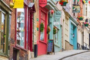 a narrow street in a city with colorful buildings at No.25 Steep Hill - Award Winning Street, Cathedral Quarter, Lincoln - Free Parking in Lincoln