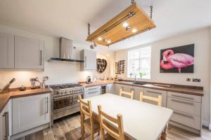 a kitchen with a table and a pink flamingo on the wall at No.25 Steep Hill - Award Winning Street, Cathedral Quarter, Lincoln - Free Parking in Lincoln