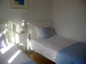 a bedroom with two beds and a lamp on a night stand at Kefalas nr Almyrida sea view cottage in Chania