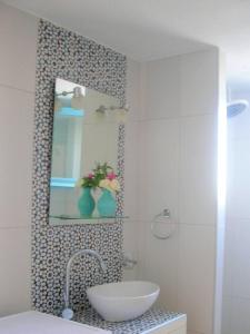 a bathroom with a sink and a mirror at Kefalas nr Almyrida sea view cottage in Chania
