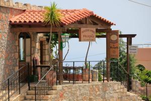 a entrance to a building with a gate at Kefalas nr Almyrida sea view cottage in Chania Town +28 photos