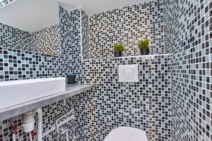 a bathroom with a sink and a toilet in it at CMG Louvre Rivoli - Châtelet in Paris