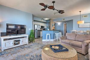 a living room with a couch and a tv at Waterfront PCB Condo with Balcony and Beach Gear! in Panama City Beach
