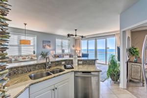 a kitchen with a sink and a view of the ocean at Bright Beachfront PCB Unit Balcony and Beach Chairs in Panama City Beach