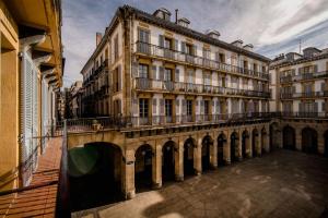 a large building with a bridge in front of it at Central Roomss in San Sebastián