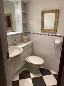 a bathroom with a toilet and a sink and a mirror at Lovely 1-Bed House in Stirling in Stirling