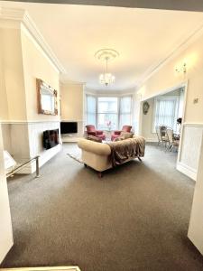 a living room with a couch and a table at Large Luxury Apartment Blackpool in Blackpool