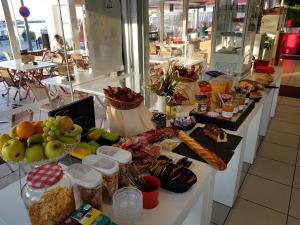 a buffet with many different types of food on a counter at Hotel-Restaurant Du Port in Mèze