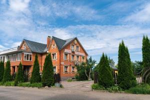 a large brick house with a black roof at Hotel Koleso in Smolensk