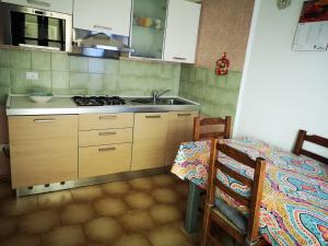 a kitchen with a sink and a stove at Eureka Azienda Agrituristica in Cavallino-Treporti