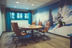 a dining room with a table and a snow mural at Gudbrandsgard Hotel in Kvitfjell +63 photos