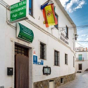 a building with a sign for a hotelreal restaurant at Hotel Rural Real de Laroles Nevada bike and treeking in Laroles