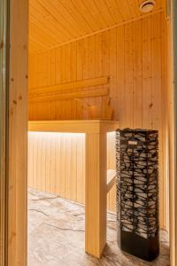 a wooden cabin with a table with a pile of wine bottles at U Repy in Bańska