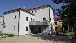 a large white building with aventh floor at Apartments ARTEMIS in Baška