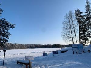 a snow covered field with signs in the snow at Pankkotupa 8B in Punkaharju