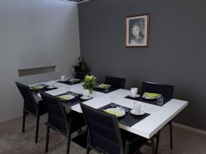 a dining room with a white table and chairs at B&B 't Walleke in Bruges
