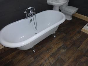 a white bath tub in a bathroom with a toilet at Sea View Cottage Lake District coast Haverigg in Millom