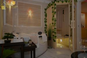 a bathroom with a tub and a sink and a shower at Spa Apartman Banja Luka in Banja Luka +37 photos