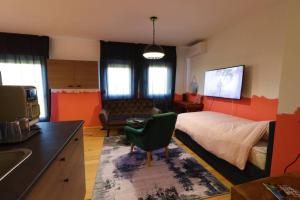 a bedroom with a bed and a kitchen with a sink at Room Emma,between bus and train station,Netflix,speed Wi-Fi in Zagreb