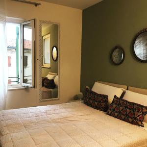 a bedroom with a bed with a large mirror at Casa Oreste in Lazise