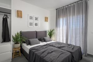 a bedroom with a large bed and a window at Seawater Villa in Lachania