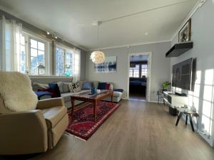 a living room with a couch and a table at Høyanger 3 roms leilighet in Høyanger