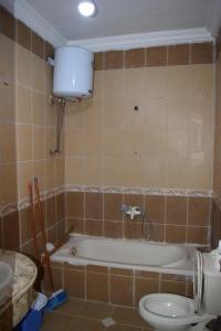 a bathroom with a bath tub and a toilet at apartment with separate entrance near Arabia hotel in Hurghada