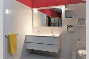 a white bathroom with a sink and a mirror at Big relax apartment with swimming pool and a peaceful garden in a private villa in Sestu +33 photos