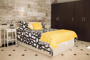 a bedroom with a black and white bed and a desk at Blonski Guadalmar in Málaga