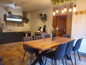a kitchen and dining room with a wooden table and chairs at Relais des Eveux in La Roche-en-Ardenne +6 photos